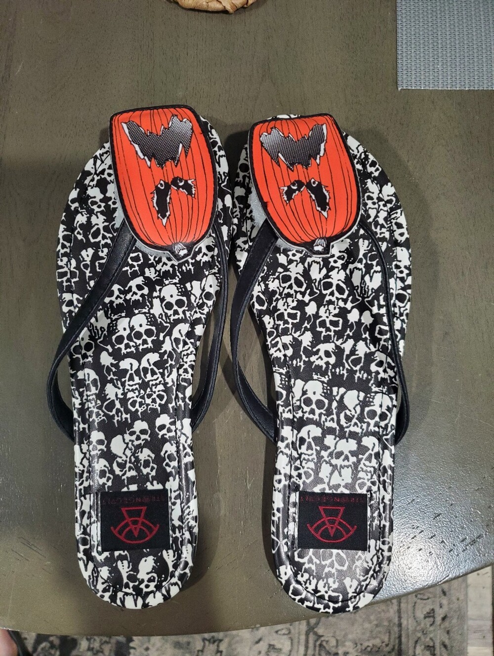 Strange Cult Skull Print Flip Flops with Orange Pumpkin Accents